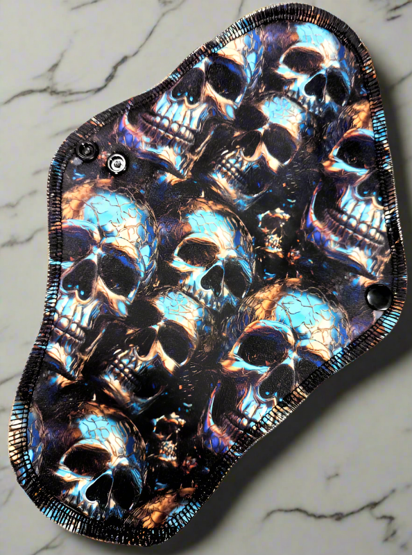 Emerald Skulls - Pique - Metallic looking skulls sticking up from the surface of the fabric with a green emerald hue.