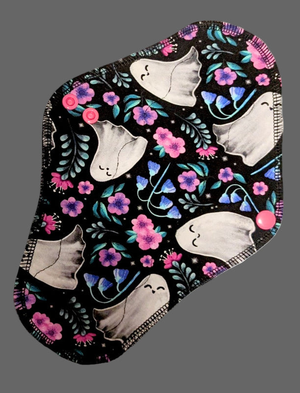 Reusable pad with ghosts and floral design on a black background