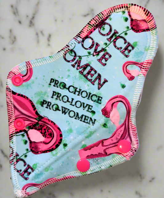 Health Care a baby blue background with green vines. Uteruses adorn this print with word PRO-CHOICE, PRO-LOVE, PRO-Women