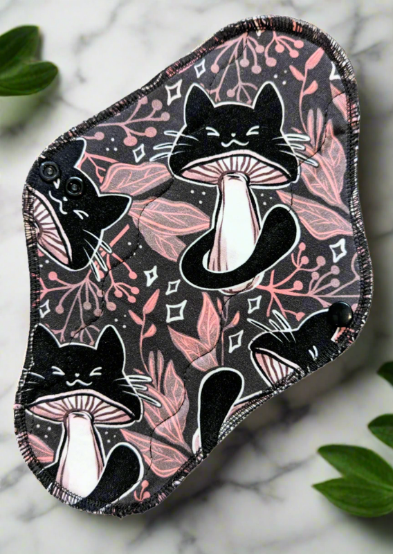 Kitty Shroom – Adorable cats shaped like mushrooms, set against a lush foliage backdrop. 