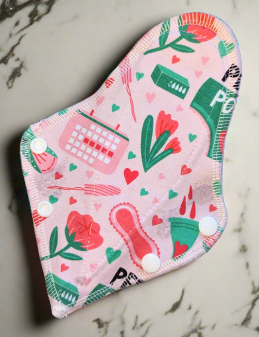 Period Power - thong shaped pad of pink background "period Power" calendars, pads tampons and flowers