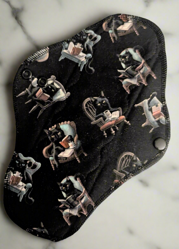 black background. different cats sitting in fancy chairs reading books