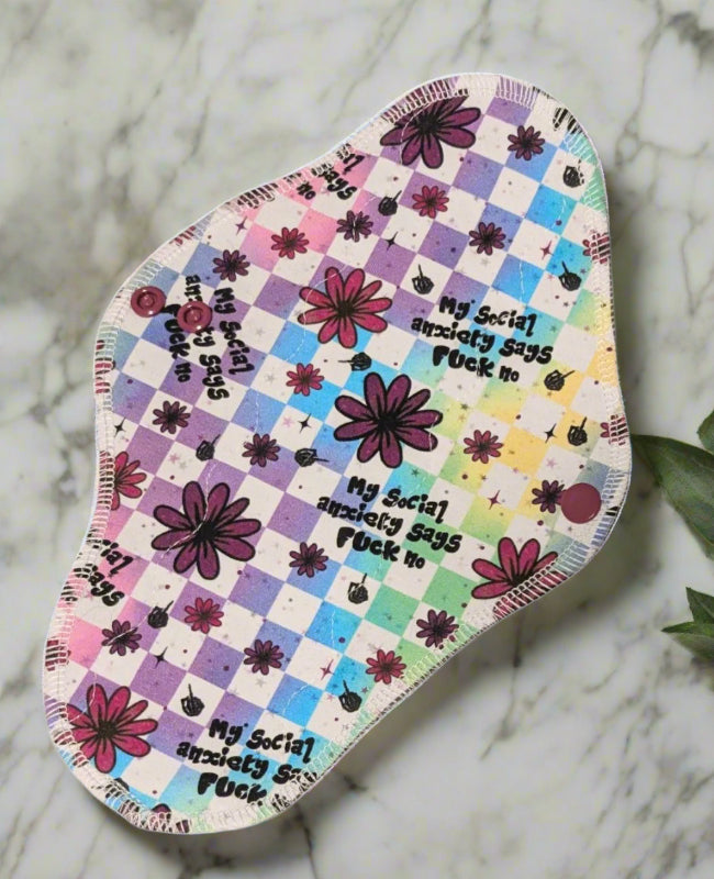 Multi coloured checkered background with flowers and the words My Social anxiety says fuck no