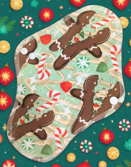 light background with icing, gum drops, mints and candy canes with brown gingerbread broken down middle 