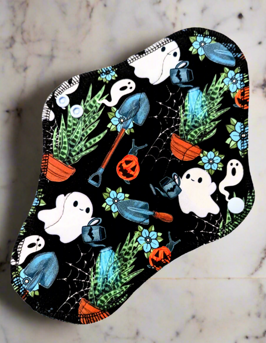 Cactus Garden Boo Watering cans, cactus in pots, pumpkin snails, lots of ghosts print on a cloth pad