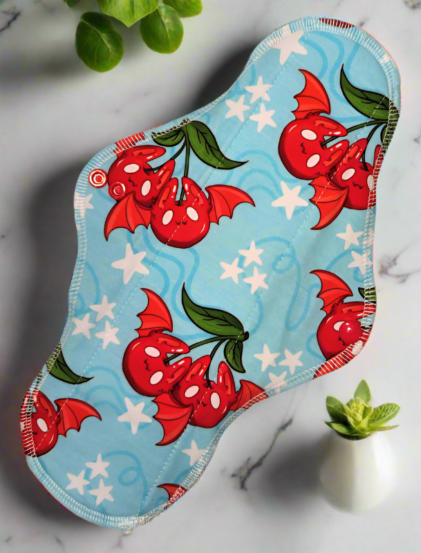 Cherry Bats – A playful design featuring cherries with bat-like wings and ears.