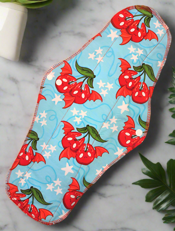 Cherry Bats – A playful design featuring cherries with bat-like wings and ears.