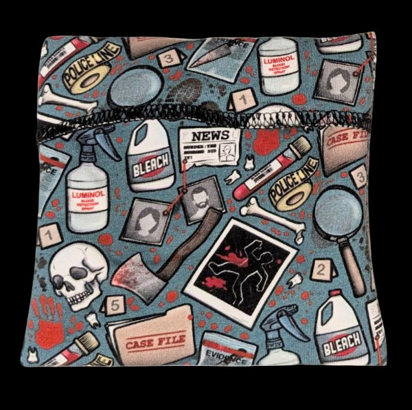 Pad Wrapper with crime-themed design featuring police tape, forensic items, and text on a blue background.