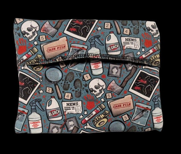Pad Wrapper with crime-themed design featuring police tape, forensic items, and text on a blue background.