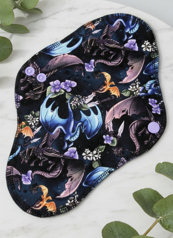 Multiple different coloured dragons in flight with flowers