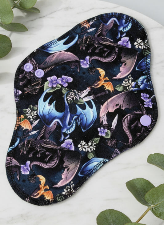 Multiple different coloured dragons in flight with flowers