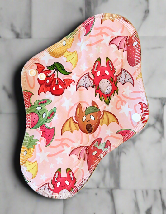 Fruit Bats - Pineapple, Mangoes, dragon fruit, watermelon, strawberries and cherries all have wings, eyes  and ears of bats on a peach background