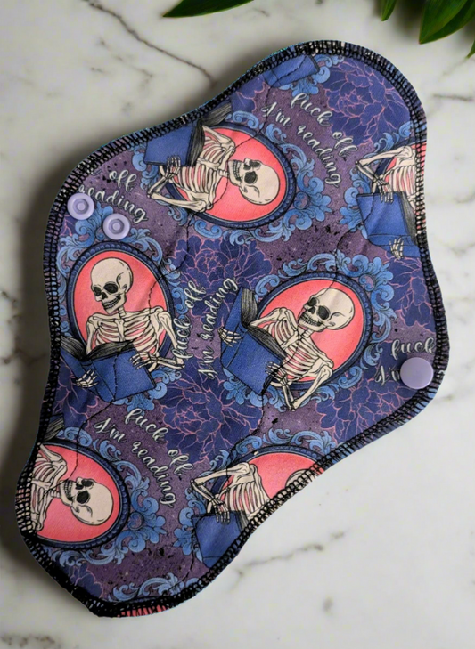 Fuck Off I'm Reading, skeletons with books on a blue and purple patterned background