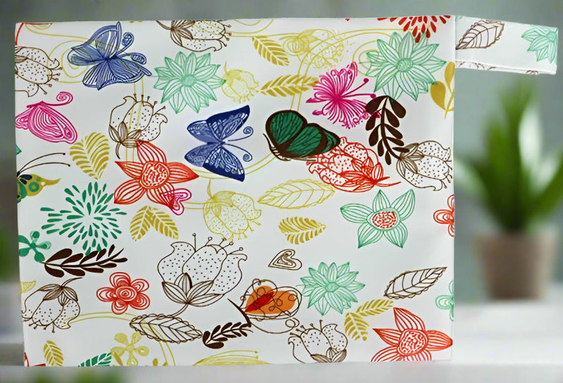 Mini wet bag featuring a vibrant butterfly print, perfect for storing small cloth pads, swimwear, or other essentials. Waterproof and travel-friendly design.