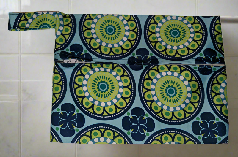 Mini wet bag featuring a modern geometric circle print, ideal for storing small cloth pads, swimwear, or other essentials. Waterproof and compact for travel.